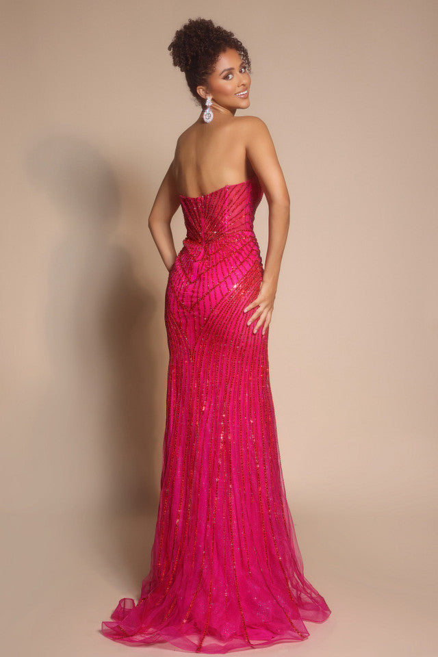 Model wearing Portia & Scarlett PS26004 strapless beaded mermaid gown with sweetheart neckline and intricate linear detailing.  Model is wearing the color fuchsia.  Back View.