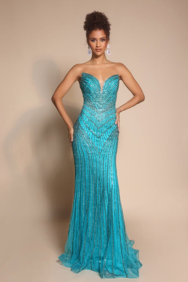 Model wearing Portia & Scarlett PS26004 strapless beaded mermaid gown with sweetheart neckline and intricate linear detailing.  Model is wearing the color peacock.