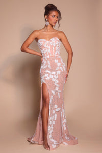 Model wearing Portia & Scarlett PS26074 strapless gown featuring floral appliqué detailing, fitted silhouette, high slit, and floor-length train.