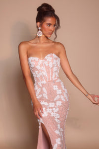 Model wearing Portia & Scarlett PS26074 strapless gown featuring floral appliqué detailing, fitted silhouette, high slit, and floor-length train.