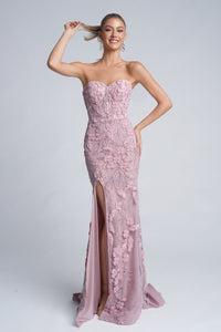 Model wearing Portia & Scarlett PS26074 strapless gown featuring floral appliqué detailing, fitted silhouette, high slit, and floor-length train.
