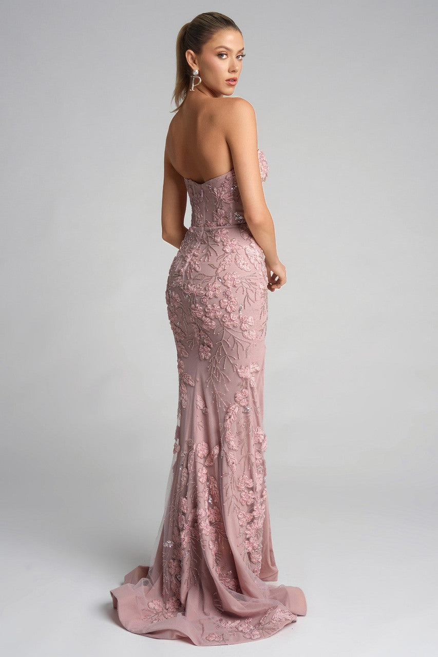 Model wearing Portia & Scarlett PS26074 strapless gown featuring floral appliqué detailing, fitted silhouette, high slit, and floor-length train.