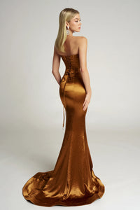 Woman wearing a gold evening gown on a white background