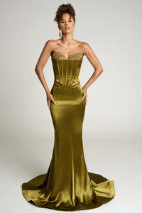 Woman wearing a strapless green evening gown with a fitted bodice and flowing skirt on a white background.