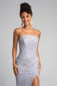 Woman wearing a strapless silver dress on a gray background