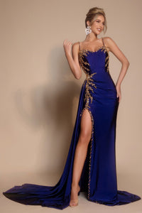 Woman wearing a blue evening gown with gold detailing on a beige background