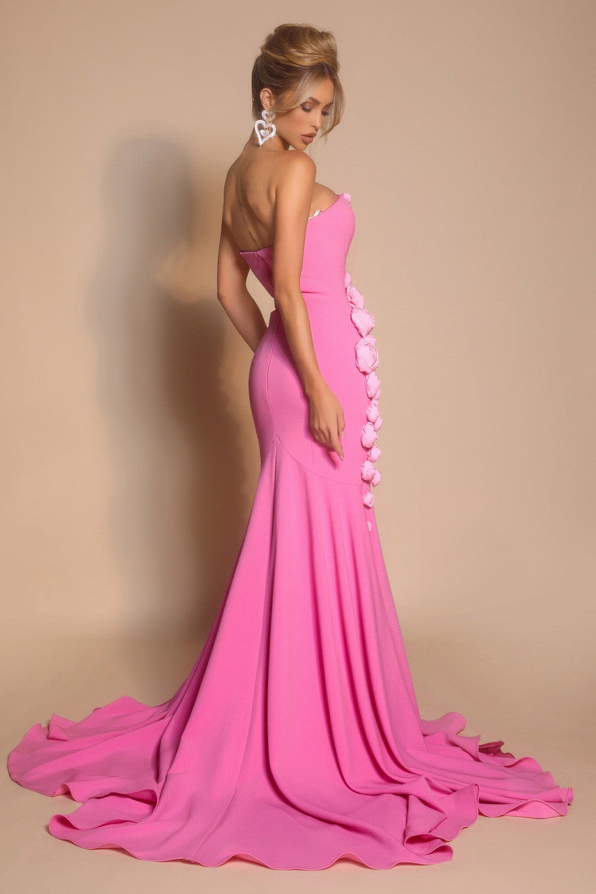 Pink evening gown with floral details on a beige background