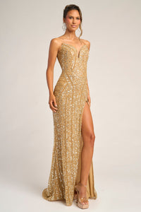 Woman wearing a gold evening gown with a high slit on a white background