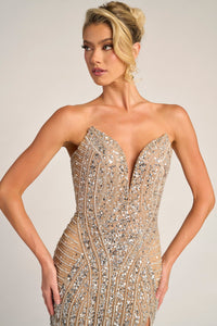 Woman wearing a strapless, beaded evening gown against a neutral background