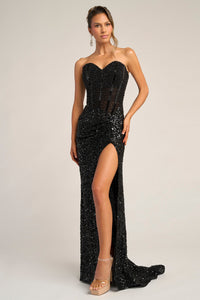 Black sequin strapless gown with a high slit on a plain background