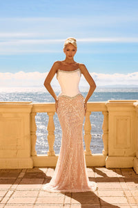 Model wearing Portia & Scarlett PS26914E strapless fitted gown with a corset bodice, crystal-trimmed neckline, embellished skirt, and sweep train.