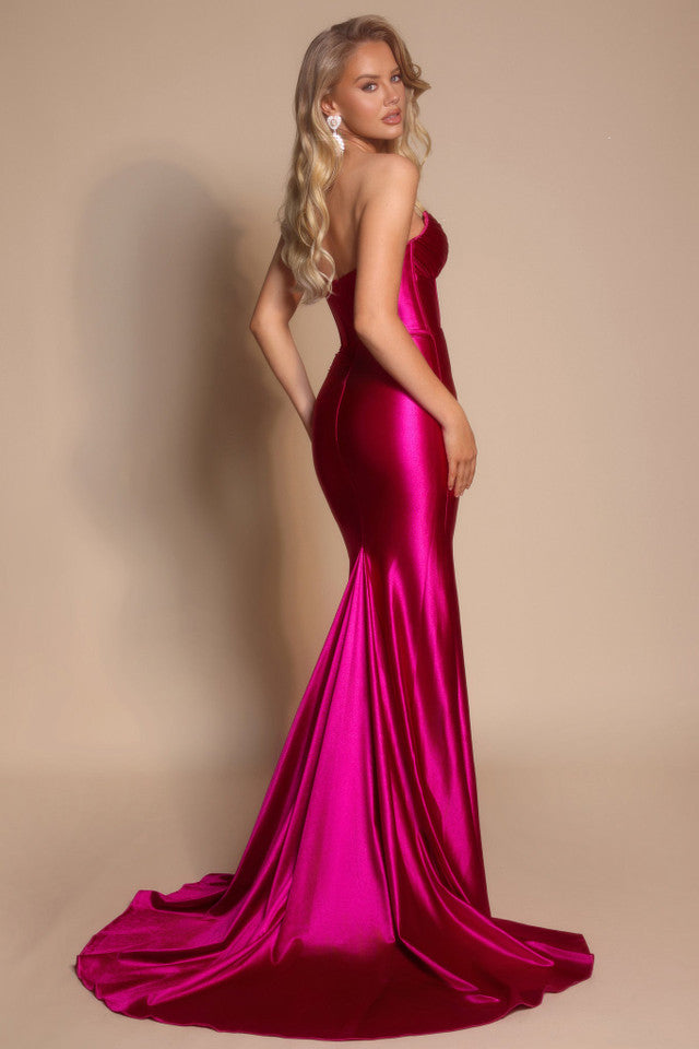 Model wearing the Portia & Scarlett XO080 strapless corset fit-and-flare gown with a structured bodice and floor-length silhouette in the color fuchsia.