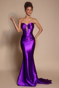 Model wearing the Portia & Scarlett XO080 strapless corset fit-and-flare gown with a structured bodice and floor-length silhouette in the color orchid.