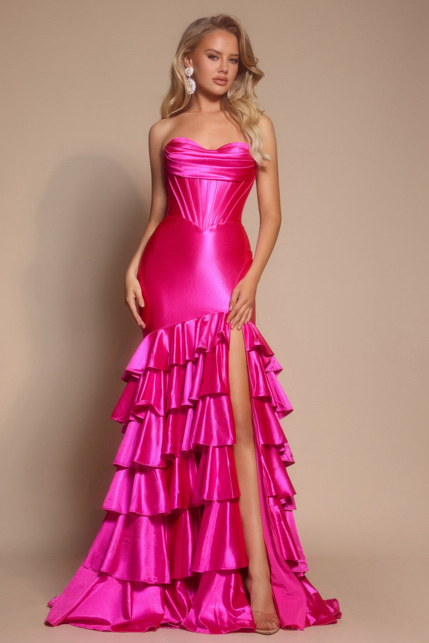 Woman wearing a fuchsia strapless gown with ruffled layers on a beige background