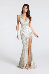 Portia & Scarlett PS27001C embellished fitted gown featuring a plunging V-neckline, geometric beading, open back, side cutouts, and thigh-high slit.  The model is wearing the dress in the color ivory-silver-gold.