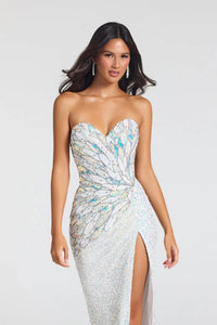 A woman modeling a strapless, sweetheart-neckline evening gown covered in shimmering silver sequins with iridescent blue, teal, and pale yellow reflective accents, photographed against a light gray studio background.