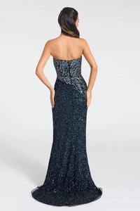 A strapless floor-length evening gown shown from the back on a model, featuring a shimmering dark navy blue sequined body with a lighter blue and silver abstract patterned bodice.