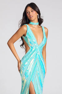 A woman modeling a sleeveless, deep V-neck, high-slit evening gown covered in shimmering turquoise sequins against a light gray studio background.