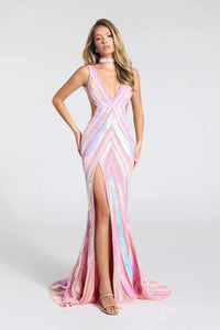 A woman modeling a sleeveless, floor-length evening gown with a deep V-neckline, thigh-high slit, and a train. The dress features a shimmering chevron pattern in pink, light blue, and white, with a matching pink choker and gold high-heeled sandals.
