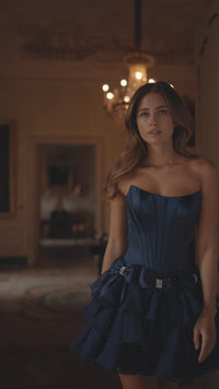 Model wearing Sherri Hill 57276 strapless satin cocktail dress with bow accents on waist and chiffon ruffle skirt.  This is a video.