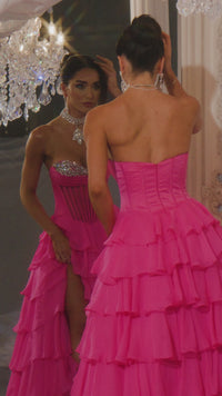 Model wearing Portia & Scarlett PS25961 gown featuring a strapless embellished bodice, sheer corset, high slit, and tiered ruffle skirt.  This is a video.