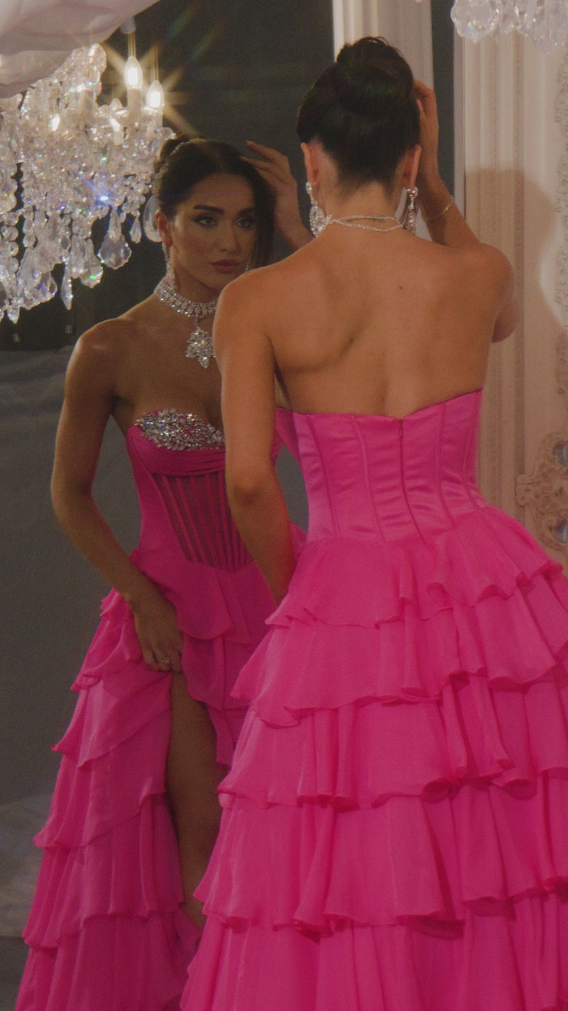Model wearing Portia & Scarlett PS25961 gown featuring a strapless embellished bodice, sheer corset, high slit, and tiered ruffle skirt.  This is a video.