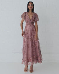 Model wearing Mac Duggal 20486 gown with faux wrap v-neckline, flutter sleeves, and rhinestone floral embellishments.  This is a video of the model wearing the dress.