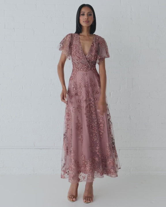 Model wearing Mac Duggal 20486 gown with faux wrap v-neckline, flutter sleeves, and rhinestone floral embellishments.  This is a video of the model wearing the dress.