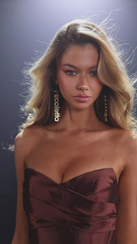 Model wearing Nicoletta NC4035 strapless A-line gown with a draped bodice, high slit, and side pockets.  This is a video.