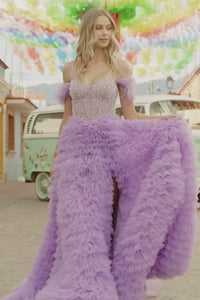 Get ready to turn heads at your prom for prom wearing this beautiful ball gown dress by Sherri Hill style number 55387. This ballgown features a stunning ruffled skirt, beaded corset top, off-the-shoulder feathered sleeves, and skirt slit. Perfect for a night of dancing and making memories with friends. Available at Madeline's Boutique in Boca Raton, Florida and Toronto, Canada.   This is a video.