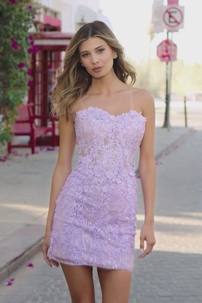 A captivating strapless cocktail dress featuring a sheer corset lace bodice embellished with sequins and 3D flower details, ideal for Bat Mitzvahs, homecoming, and graduations. Available at Madeline's Boutique in Toronto and Boca Raton.  Video of Model wearing Dress.