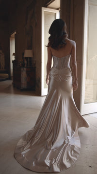 Model wearing Sherri Hill 57473 strapless fitted gown with sparkling hot fix corset and high-slit skirt. This is a video.