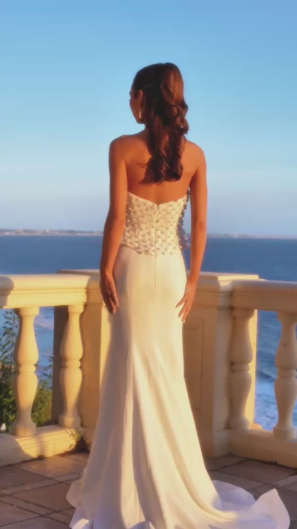 Model wearing Portia & Scarlett PS26907E pearl-embellished corset mermaid gown with a strapless neckline.  This is a video.