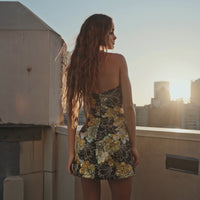 Model wearing the Helsi Brady DR6488 strapless mini dress featuring sequin floral appliqués and a flared silhouette. This is a video.