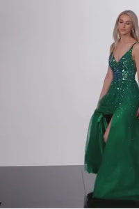 A luxurious embellished A-line prom dress with high slit and V neckline, perfect for prom night. This dress is a video of the model wearing the dress in the color Emerald.