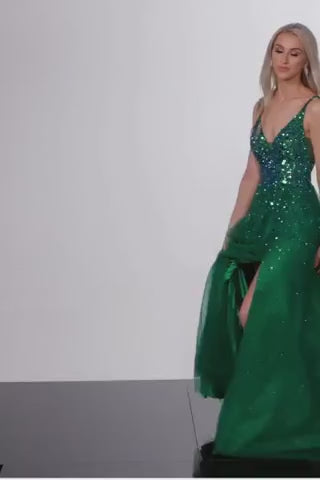 A luxurious embellished A-line prom dress with high slit and V neckline, perfect for prom night. This dress is a video of the model wearing the dress in the color Emerald.