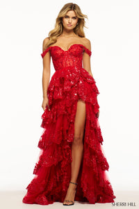 A captivating tulle sequin A-line gown with a sheer corset bodice, off-the-shoulder straps, and a ruffle high slit skirt. Ideal for prom, red carpet events, and pageants.