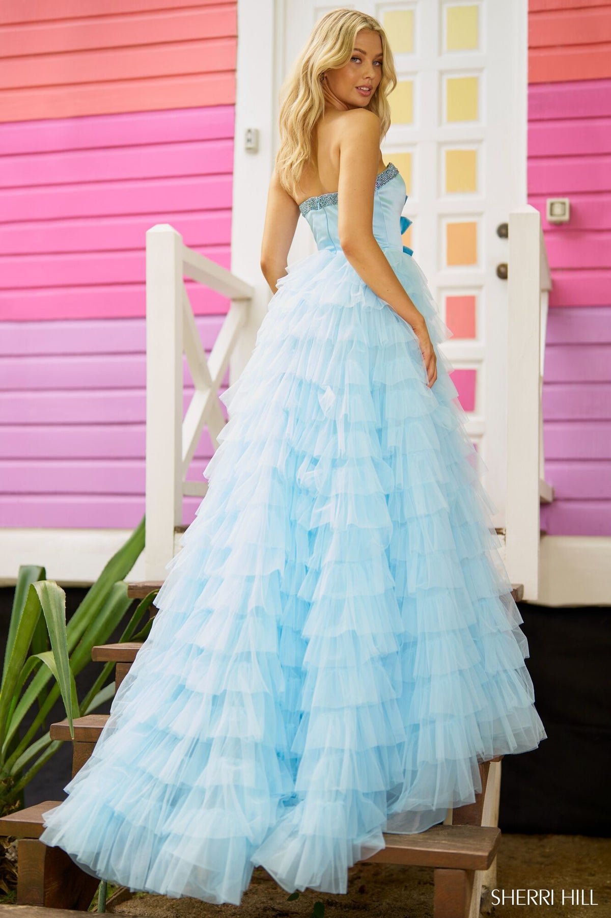 Sherri Hill 56012 Strapless A-line Prom and Quinceañera Gown - An enchanting gown featuring a strapless A-line silhouette, deep V neckline, bow embellishments, and a ruffle skirt with a slit for an elegant and timeless look.