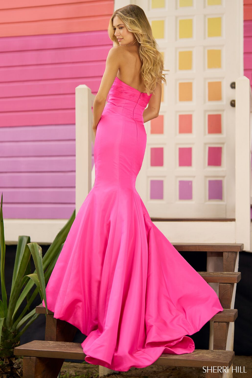 A mesmerizing strapless taffeta mermaid prom gown with a ruched neckline, keyhole, and intricate flower detail on the bodice. Perfect for prom or evening events.