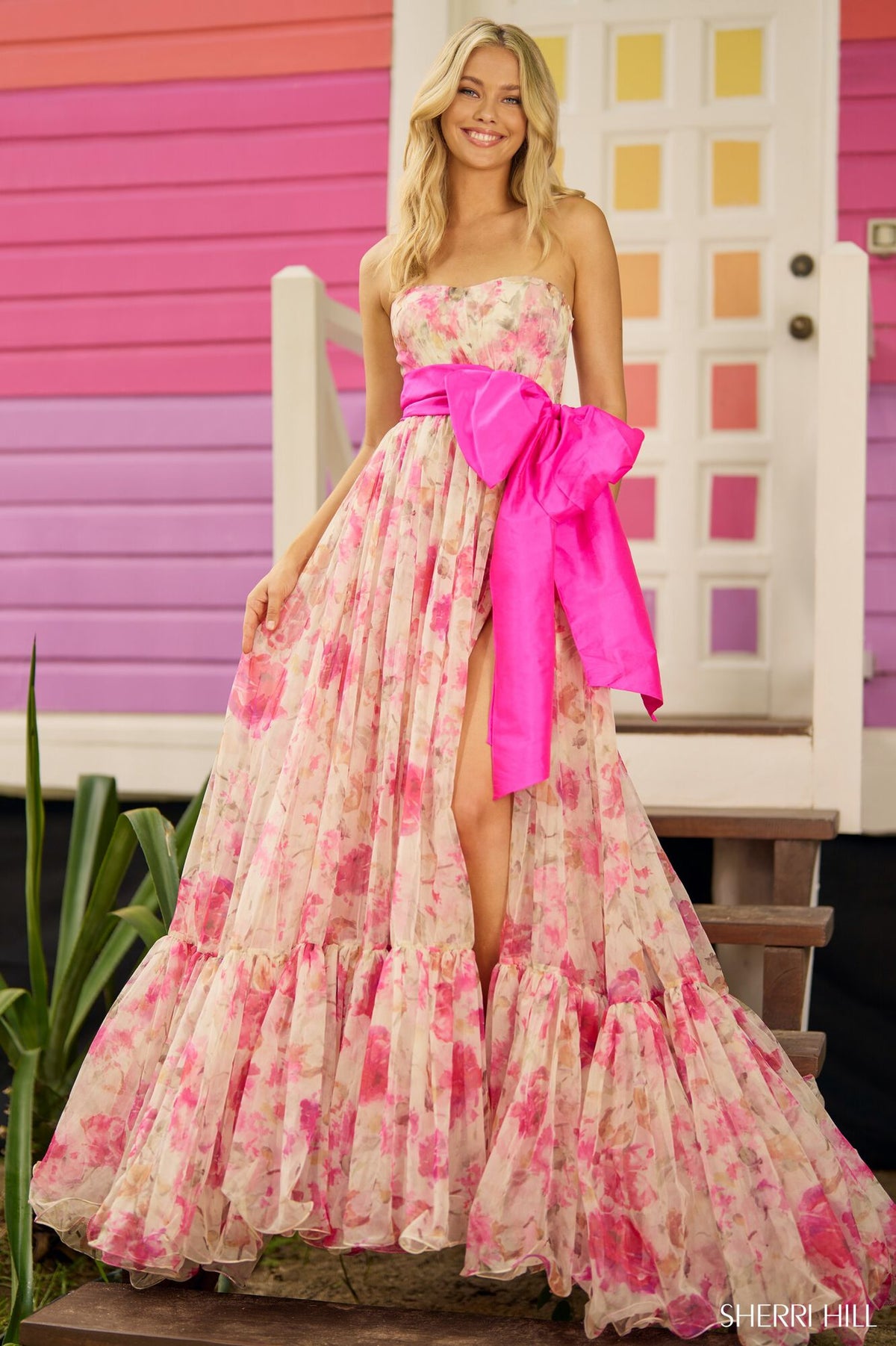 Sherri Hill 56110 - An elegant floral print ball gown with a strapless design, taffeta bow detail, and subtle skirt slit, perfect for a romantic and enchanting prom night.