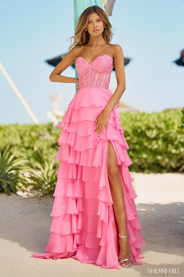 The Sherri Hill Strapless Leaf Lace Gown, a stunning ensemble featuring a leaf lace corset top, chiffon ruffle skirt with slit, and a lace-up back. Perfect for proms and formal events.