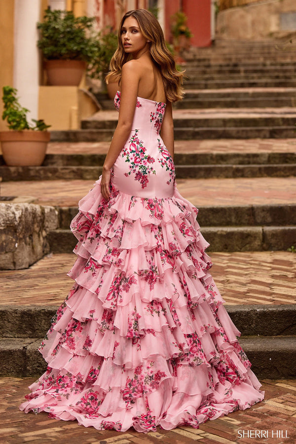 Model wearing Sherri Hill 57144 strapless gown with a fitted bodice and cascading ruffled tiered skirt.