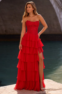 Model wearing Sherri Hill 57336 strapless gown with leaf lace corset bodice and layered chiffon ruffle skirt with slit.