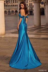 Model wearing Sherri Hill 57454 gown featuring off-the-shoulder sleeves, corset bodice, lace-up back, and high slit.