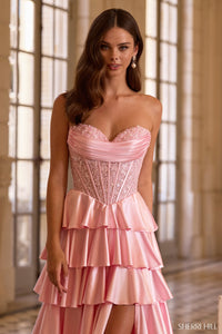 Model wearing Sherri Hill 57556 strapless gown with corset bodice, tiered ruffle skirt, high slit, and lace-up back.