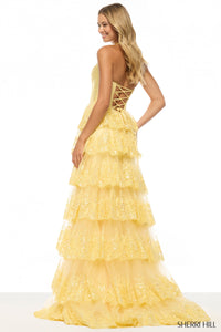 Yellow tiered dress with lace-up back on a white background, Sherry Hill brand visible.