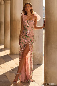 Model wearing Sherri Hill 57602 fitted gown with beaded floral detailing, shoulder bows, and skirt slit.