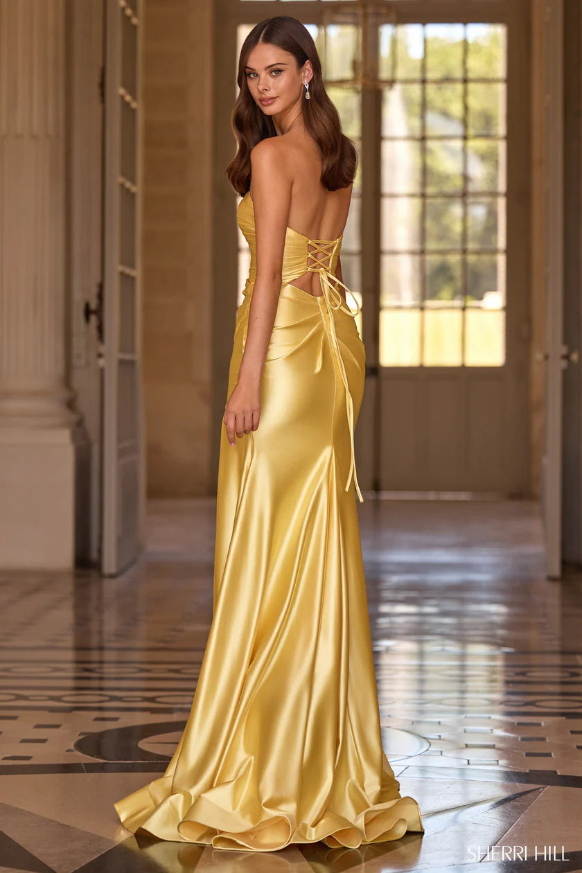Woman wearing a yellow evening gown in an elegant interior setting