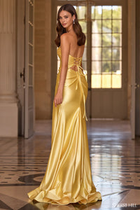 Woman wearing a yellow evening gown in an elegant interior setting