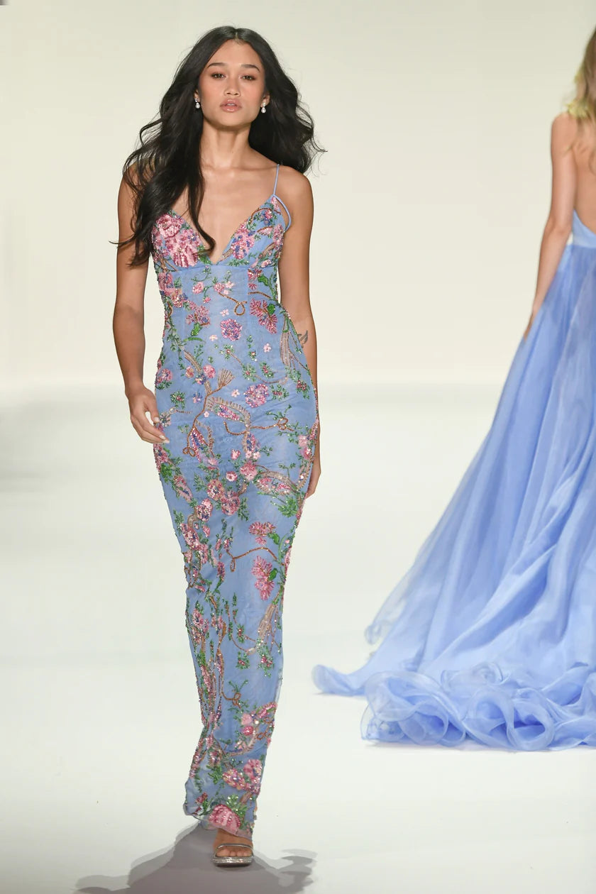 Woman wearing a blue floral dress on a white background